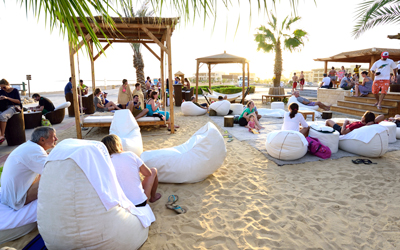 Beach bar with cozy bean bags on the sandy shore at sunset – relax with a view of the Red Sea at The Breakers Somabay.